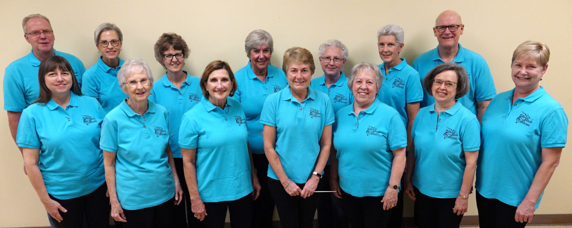 A group of women in blue shirts standing next to each other.